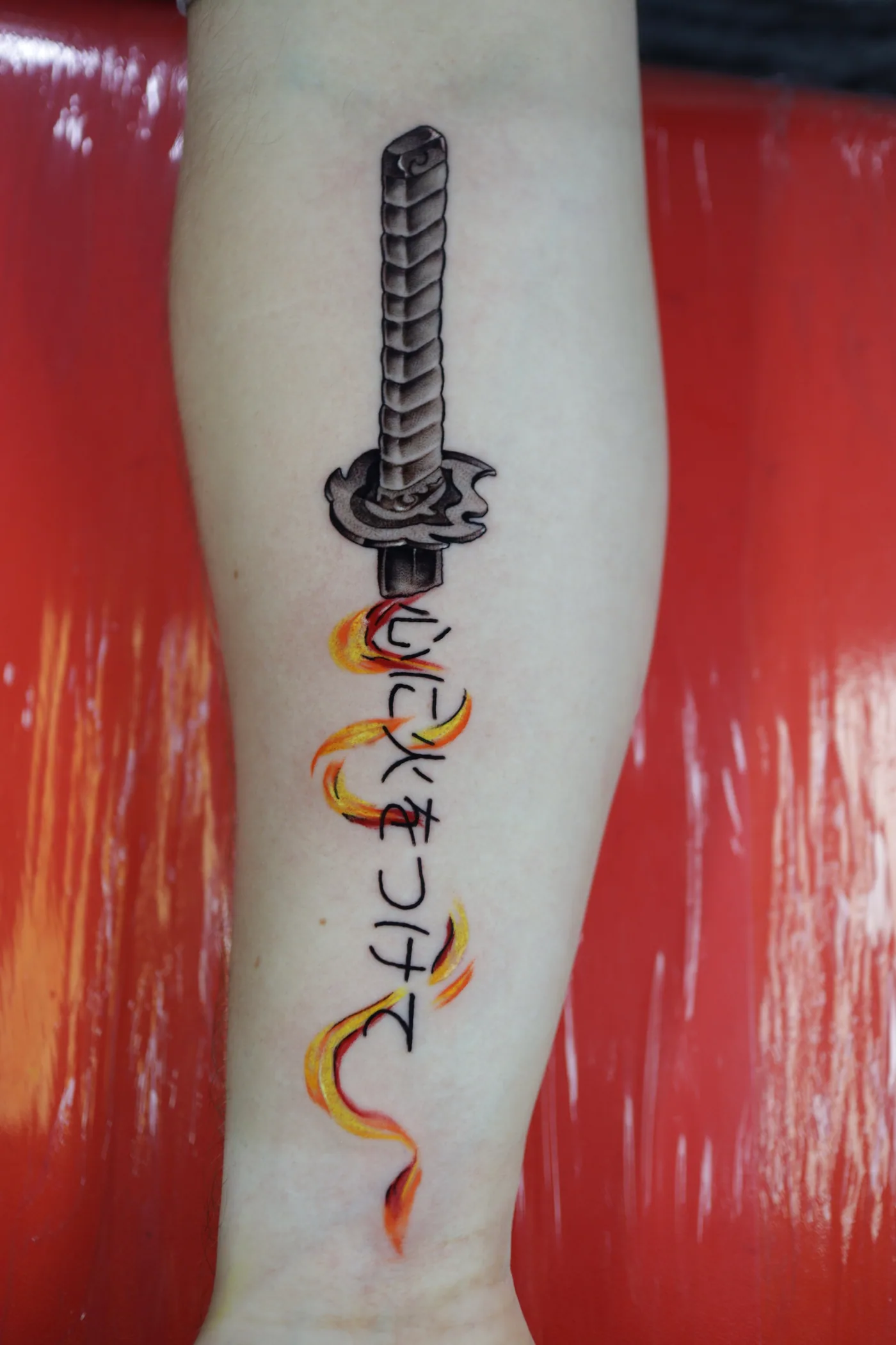 Sword and floral detail tattoo by Eddie Gonzalez